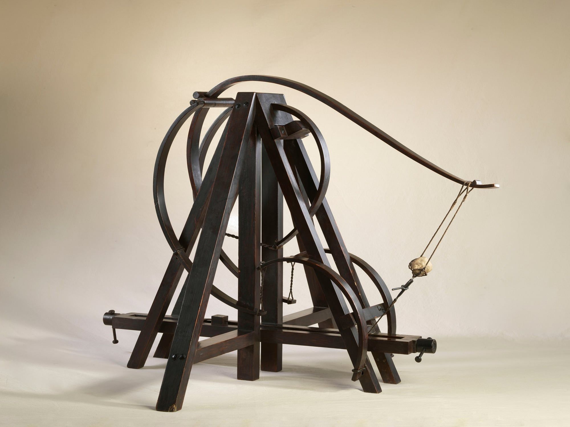 Wooden reconstructions of Leonardo da Vinci's flying machine and gears displayed in a museum hall in Rome